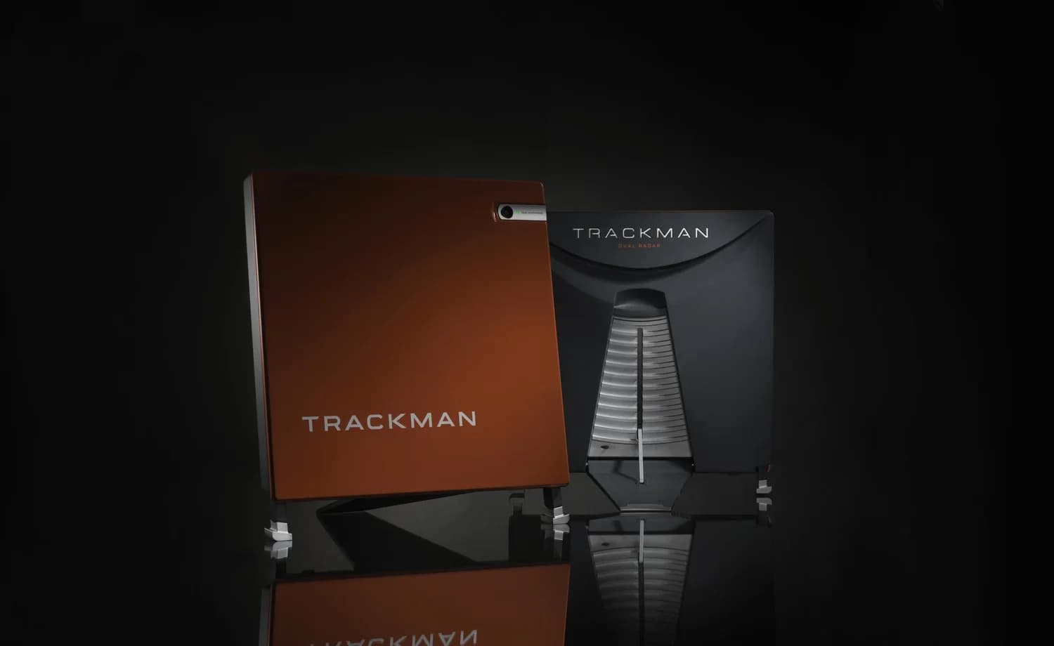 Front and rear views of a TrackMan launch monitor against a black background